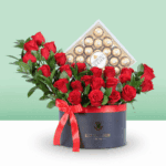 Luxury black flower box filled with red roses and greenery.