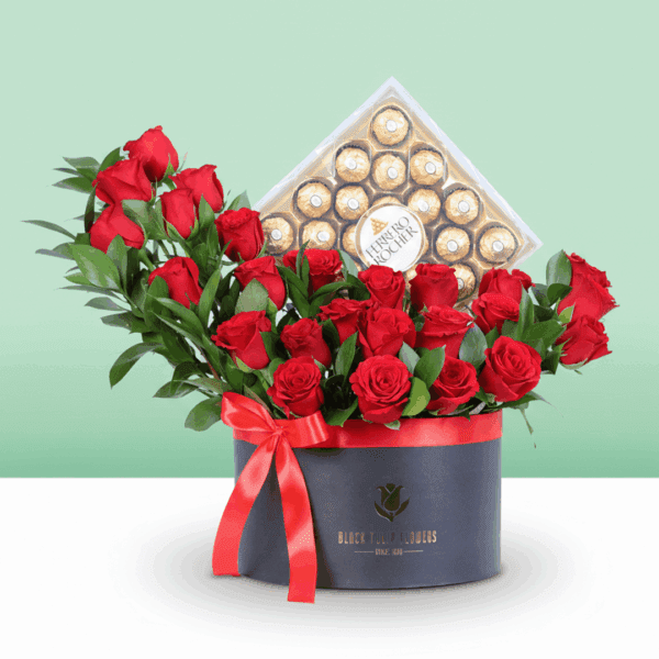 Luxury black flower box filled with red roses and greenery.
