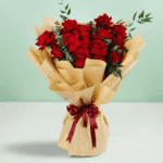 Red roses bouquet with baby’s breath wrapped in white and tied with a black ribbon.