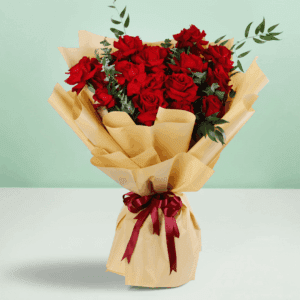 Red roses bouquet with baby’s breath wrapped in white and tied with a black ribbon.