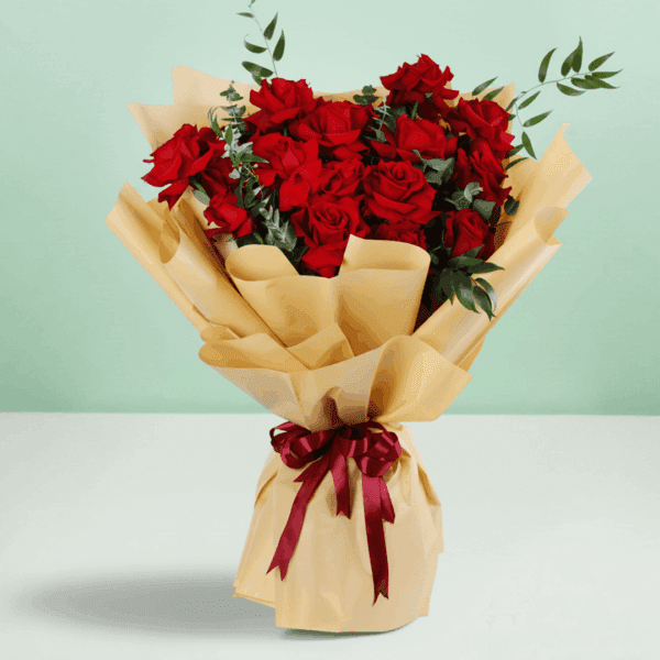 Red roses bouquet with baby’s breath wrapped in white and tied with a black ribbon.