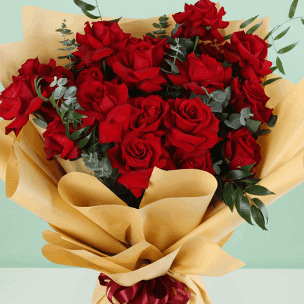 Red roses bouquet with baby’s breath wrapped in white and tied with a black ribbon.