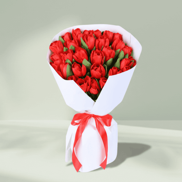 red-tulip-elegance-bouquet (1) "A vibrant bouquet of 30 red tulips, elegantly wrapped in soft non-woven paper"