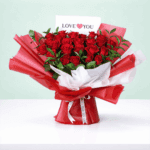 Fresh cut red roses arranged with foliage, wrapped in stylish Korean sheets with a "Love You" printed card