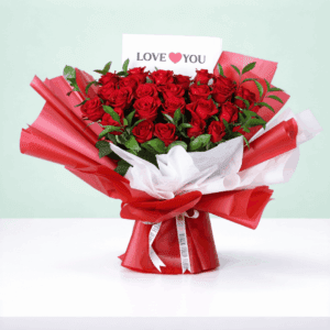 Fresh cut red roses arranged with foliage, wrapped in stylish Korean sheets with a "Love You" printed card