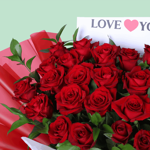 Fresh cut red roses arranged with foliage, wrapped in stylish Korean sheets with a "Love You" printed card