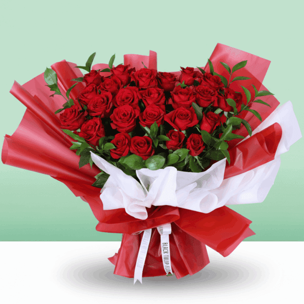 Fresh cut red roses arranged with foliage, wrapped in stylish Korean sheets with a "Love You" printed card