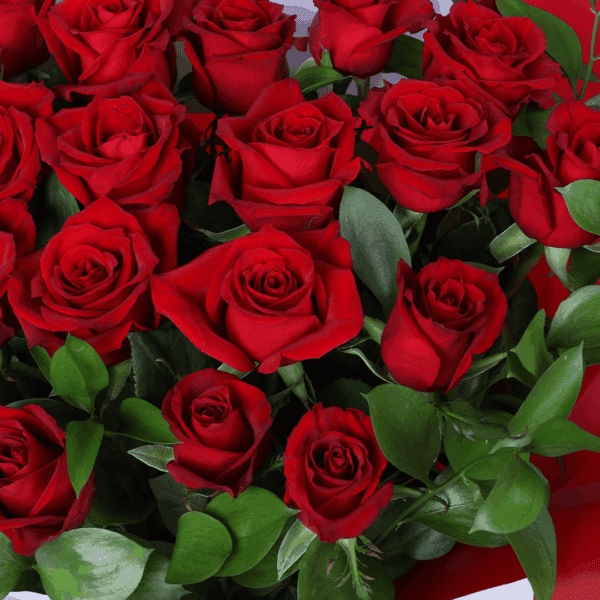 Fresh cut red roses arranged with foliage, wrapped in stylish Korean sheets with a "Love You" printed card