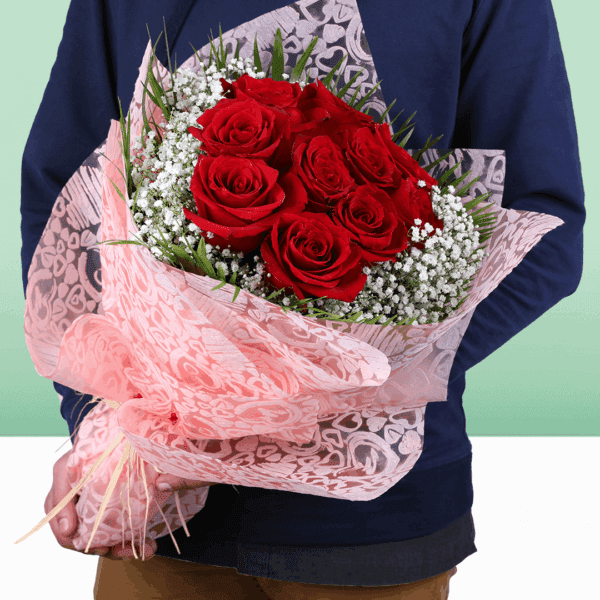 Fresh red roses with soft gypso accents, wrapped in non-woven paper and finished with a golden "Love You" topper