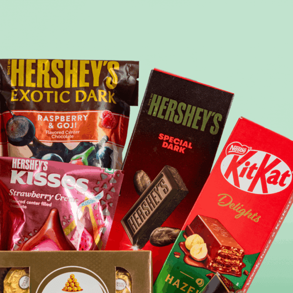 Box of red roses with 15 exotic chocolates arranged neatly in a rectangle basket with a bow tied.