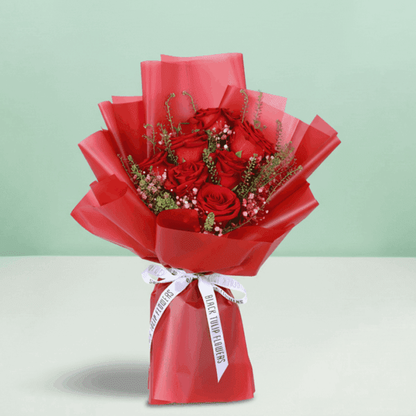 "Fifty red roses arranged elegantly, wrapped in Korean-style flower sheets and topped with a “Love You” sign"