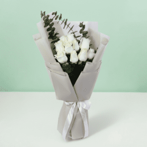 A bouquet of white roses and eucalyptus in a soft white wrap.