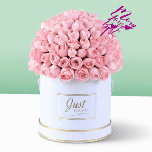 White round box filled with neatly arranged pink roses with a Mother’s Day topper placed on top, premium floral gift arrangement for Mom