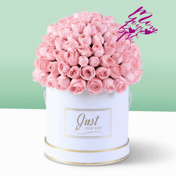 White round box filled with neatly arranged pink roses with a Mother’s Day topper placed on top, premium floral gift arrangement for Mom
