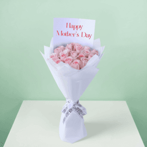 Roses arranged in a bouquet with soft non-woven wrapping with a white ribbon and decorative presentation