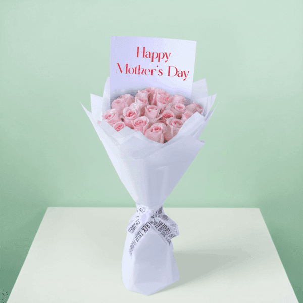 Roses arranged in a bouquet with soft non-woven wrapping with a white ribbon and decorative presentation