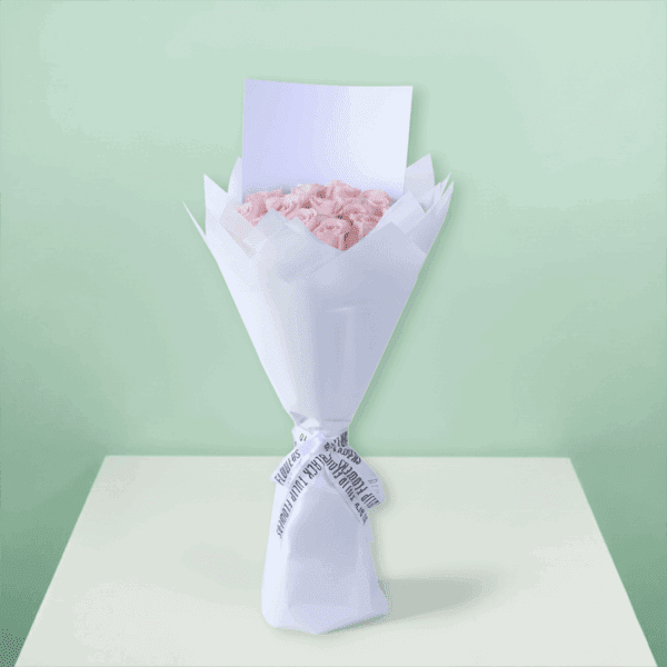 Roses arranged in a bouquet with soft non-woven wrapping with a white ribbon and decorative presentation
