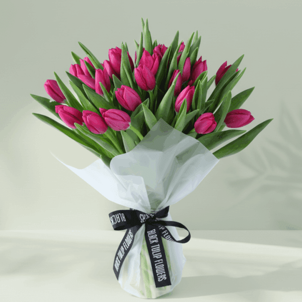 Mom’s Tulip Harmony (4) Hand-tied bouquet of 30 pink tulips in Korean-style wrapping sheets in white and tied with black satin ribbon