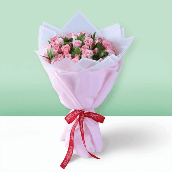 Fresh roses and spray roses bouquet with neat wrapping and a small Mother’s Day card attached