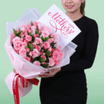 Fresh roses and spray roses bouquet with neat wrapping and a small Mother’s Day card attached