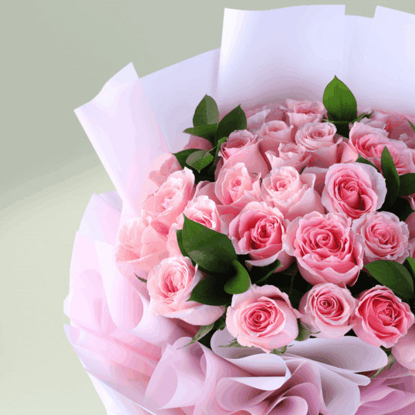 Floral arrangement of roses and spray roses in non-woven wrap with a message card styled for Mother’s Day gifting