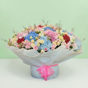 Premium pastel flower bouquet with hydrangeas, roses, eustomas, and wax flowers in a luxurious floral arrangement.
