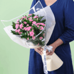 Beautifully hand-crafted 20 stem red carnation bouquet layered with fresh green leaves and wrapped in non woven paper.