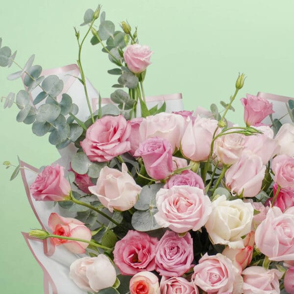 An exquisite bouquet of 30–35 stems of assorted roses, sweet eustoma, and fresh eucalyptus, wrapped beautifully in Korean-style white paper.