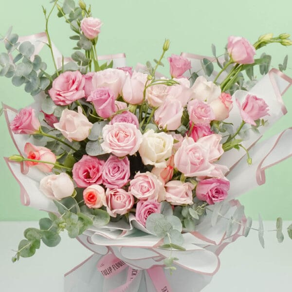 An exquisite bouquet of 30–35 stems of assorted roses, sweet eustoma, and fresh eucalyptus, wrapped beautifully in Korean-style white paper.