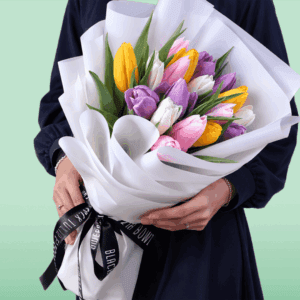 Fresh assorted tulip bouquet featuring 20 colorful stems wrapped beautifully in a non-woven floral paper.