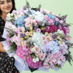 A vibrant assortment of flowers wrapped together, showcasing various colors and types in a decorative arrangement.