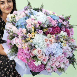 A vibrant assortment of flowers wrapped together, showcasing various colors and types in a decorative arrangement.
