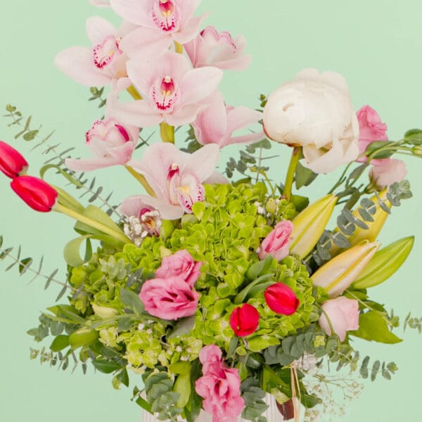 Mixed fresh flower bouquet arranged in a premium ceramic vase with a vibrant and elegant presentation.
