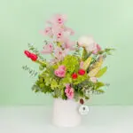 Mixed fresh flower bouquet arranged in a premium ceramic vase with a vibrant and elegant presentation.