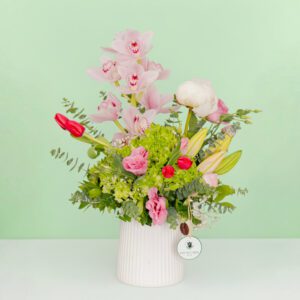 Mixed fresh flower bouquet arranged in a premium ceramic vase with a vibrant and elegant presentation.