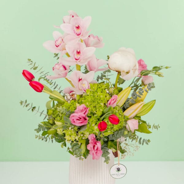 Mixed fresh flower bouquet arranged in a premium ceramic vase with a vibrant and elegant presentation.