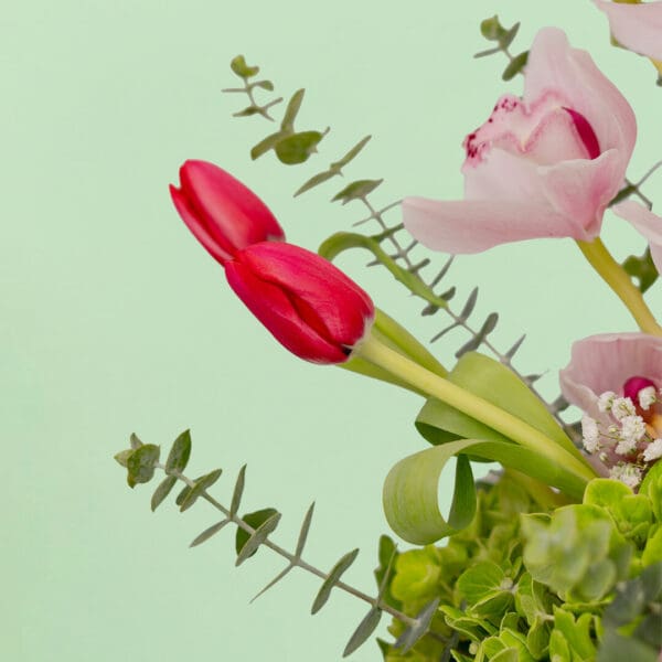 Mixed fresh flower bouquet arranged in a premium ceramic vase with a vibrant and elegant presentation.