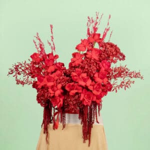 Luxurious red floral creation with high-quality fresh blooms & dried elements artistically arranged in an elegant white round gift box