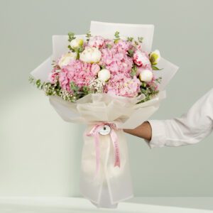 15-stem pink flower bouquet featuring peonies, hydrangeas, and fresh eucalyptus elegantly wrapped in Korean-style white wrapping sheets.