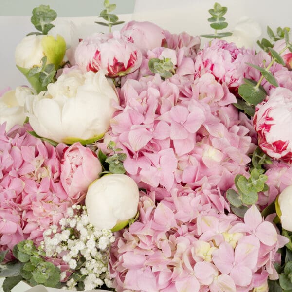 15-stem pink flower bouquet featuring peonies, hydrangeas, and fresh eucalyptus elegantly wrapped in Korean-style white wrapping sheets.