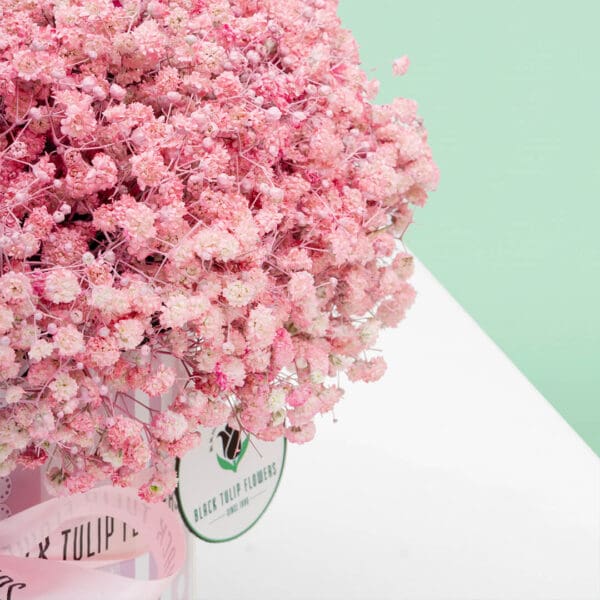 Luxury pink baby's breath flower box showcasing delicate gypsophila blooms artistically presented in a premium round box.