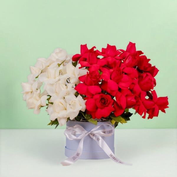 Romantic flower box with thirty premium red and white roses beautifully styled in a luxurious round presentation box.