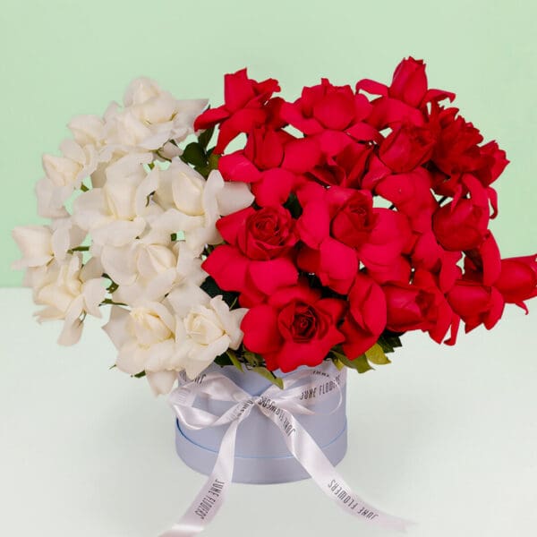 Romantic flower box with thirty premium red and white roses beautifully styled in a luxurious round presentation box.