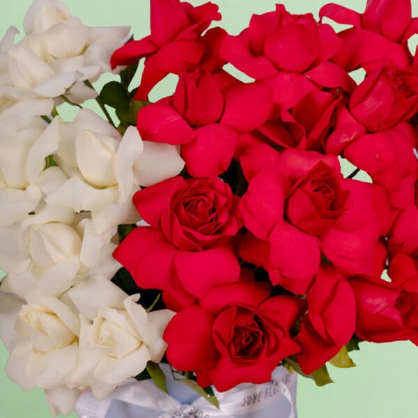 Romantic flower box with thirty premium red and white roses beautifully styled in a luxurious round presentation box.