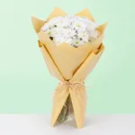 A beautiful gathering of 10 fresh white chrysanthemums arranged in a stylish floral wrap.
